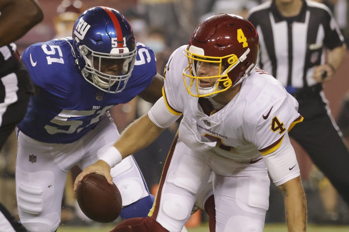 Washington quarterback Taylor Heinicke (4) is sacked by New York Giants linebacker Azeez Ojulari (51). Mandatory Credit: Geoff Burke-USA TODAY 